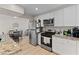 Open kitchen featuring stainless steel appliances, granite countertops, and bright dining area at 2712 Holmes St, North Las Vegas, NV 89030