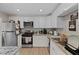 Bright kitchen features stainless steel appliances, white cabinetry, and granite countertops at 2712 Holmes St, North Las Vegas, NV 89030