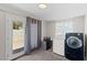 Laundry room featuring a washer, dryer, carpeted floors and access to the backyard at 2712 Holmes St, North Las Vegas, NV 89030