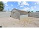 Rear yard featuring a stucco storage shed with a minimalist design, complementing the surrounding landscape at 2712 Holmes St, North Las Vegas, NV 89030