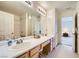 Well-lit bathroom featuring a double vanity and a separate shower area at 2902 Aztec Lily Ln, Henderson, NV 89074
