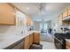 Bright kitchen featuring light wood cabinetry, white countertops, and modern appliances overlooking dining area at 2902 Aztec Lily Ln, Henderson, NV 89074