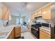 Well-lit kitchen showcasing wood cabinets, stainless steel appliances, and an open view to the dining area at 2902 Aztec Lily Ln, Henderson, NV 89074