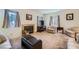 Inviting living room with a fireplace, comfortable seating, and natural light at 2902 Aztec Lily Ln, Henderson, NV 89074