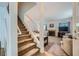 Cozy living room with plush carpeting, fireplace, and staircase at 2902 Aztec Lily Ln, Henderson, NV 89074