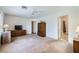 Large main bedroom with neutral carpet, ceiling fan, and doorways to closet and en-suite bathroom at 2902 Aztec Lily Ln, Henderson, NV 89074