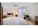Spacious main bedroom with carpet, a ceiling fan, and large window for ample natural light at 2902 Aztec Lily Ln, Henderson, NV 89074