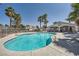 Beautiful community pool surrounded by lush landscaping and inviting lounge area at 2902 Aztec Lily Ln, Henderson, NV 89074