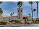 Beautiful building with a tower, tile roof, and lush landscaping at 3150 Soft Breezes Dr # 2046, Las Vegas, NV 89128
