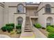 Close-up of a condo building with stucco exterior, arched windows, and access stairs at 3150 Soft Breezes Dr # 2046, Las Vegas, NV 89128
