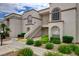 Charming condo building featuring lush landscaping and easy access stairs, enhancing the overall appeal at 3150 Soft Breezes Dr # 2046, Las Vegas, NV 89128