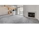Spacious living room featuring a fireplace and kitchen access, creating a welcoming and functional area at 3150 Soft Breezes Dr # 2046, Las Vegas, NV 89128