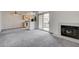 Open-concept living room showcasing fireplace and kitchen, providing an ideal space for relaxation and entertainment at 3150 Soft Breezes Dr # 2046, Las Vegas, NV 89128