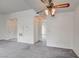 Open living room with ceiling fan, neutral carpet, and multiple entrances to the rooms at 3150 Soft Breezes Dr # 2046, Las Vegas, NV 89128