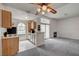 Open-concept living area with a kitchen, fireplace, ceiling fan, and sliding glass doors to the balcony at 3150 Soft Breezes Dr # 2046, Las Vegas, NV 89128