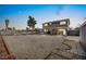 A spacious backyard with a large gravel area surrounding a two-story home with a covered patio at 3208 Alcoa Ave, Las Vegas, NV 89102