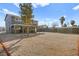 Wide shot showcasing the expansive gravel backyard, home, and covered patio at 3208 Alcoa Ave, Las Vegas, NV 89102