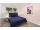 Bedroom featuring neutral carpet, soft pink accent wall, and bright natural light at 3208 Alcoa Ave, Las Vegas, NV 89102