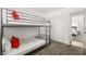 Cozy bedroom with carpet, featuring a bunk bed with red accent pillows at 3208 Alcoa Ave, Las Vegas, NV 89102
