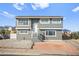 Two-story home with neutral color scheme, brick accents, gravel yard, and desert landscaping at 3208 Alcoa Ave, Las Vegas, NV 89102