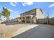 Rear exterior showcasing a house with large gravel yard, carport and fenced perimeter at 3208 Alcoa Ave, Las Vegas, NV 89102