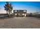 Two-story gray home featuring a large gravel-covered yard and covered front porch at 3208 Alcoa Ave, Las Vegas, NV 89102