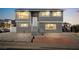 A gray two-story home with white trim and a small landscaped front yard at 3208 Alcoa Ave, Las Vegas, NV 89102