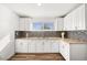 Contemporary kitchen with granite countertops, mosaic backsplash, and stainless steel sink at 3208 Alcoa Ave, Las Vegas, NV 89102