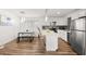 Modern kitchen featuring stainless steel appliances, white cabinetry, and island seating at 3208 Alcoa Ave, Las Vegas, NV 89102