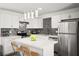 Modern kitchen features stainless steel appliances, center island, stone countertops, and attractive backsplash at 3208 Alcoa Ave, Las Vegas, NV 89102
