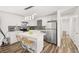 Well-lit kitchen with white cabinets, a stylish backsplash, stainless appliances and center island at 3208 Alcoa Ave, Las Vegas, NV 89102