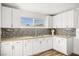 Bright kitchen with white cabinets, mosaic backsplash, granite countertops, and stainless steel sink at 3208 Alcoa Ave, Las Vegas, NV 89102