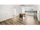 Open-concept living room with wood-look floors, neutral walls, and a foosball table at 3208 Alcoa Ave, Las Vegas, NV 89102