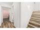 Hallway with staircase, featuring wood-look floors and access to another room at 3208 Alcoa Ave, Las Vegas, NV 89102