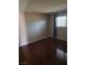Neutral bedroom featuring wood-look laminate flooring and window with diamond pattern at 3314 Arapaho, Las Vegas, NV 89169