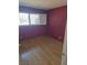 Bedroom with hardwood floors, a window, and plum colored walls at 3314 Arapaho, Las Vegas, NV 89169