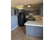Updated kitchen featuring dark cabinets, modern appliances, and tile countertops at 3314 Arapaho, Las Vegas, NV 89169