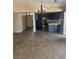 Open-concept living room and kitchen featuring tile floors, dark cabinetry, and traditional chandelier at 3314 Arapaho, Las Vegas, NV 89169