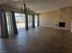 Spacious living room with stone fireplace, tile flooring, and access to the backyard at 3314 Arapaho, Las Vegas, NV 89169