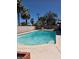 A refreshing in-ground swimming pool surrounded by a concrete patio and palm trees, perfect for outdoor relaxation at 3314 Arapaho, Las Vegas, NV 89169