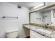 Bright bathroom with granite counters, large mirror, modern vanity, and a shower and tub at 3930 University Center Dr # 311, Las Vegas, NV 89119