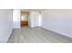 Open bedroom with wood-style flooring leading to a bathroom vanity at 3930 University Center Dr # 311, Las Vegas, NV 89119