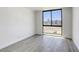 Bright bedroom with a large window and wood-style flooring at 3930 University Center Dr # 311, Las Vegas, NV 89119