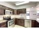 Updated kitchen showcasing stainless steel appliances and dark wood cabinets at 3930 University Center Dr # 311, Las Vegas, NV 89119