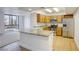Open kitchen with wooden cabinets, stainless steel appliances, and granite countertops at 3930 University Center Dr # 311, Las Vegas, NV 89119