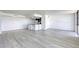 Bright, open living space featuring wood-look flooring and an open layout to the kitchen and outdoor view at 3930 University Center Dr # 311, Las Vegas, NV 89119
