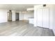 Spacious open living area featuring wood-look floors, with an open floorplan to the kitchen and large closet at 3930 University Center Dr # 311, Las Vegas, NV 89119