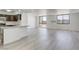 Spacious, bright living space with wood-look flooring, and an open layout to the kitchen with many windows at 3930 University Center Dr # 311, Las Vegas, NV 89119