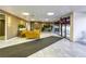 Inviting lobby area with stylish yellow couches, plants, and tile flooring with modern decor at 3930 University Center Dr # 311, Las Vegas, NV 89119