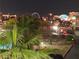 Night skyline view showcasing the community outdoor patio and pool with the Las Vegas strip in the distance at 3930 University Center Dr # 311, Las Vegas, NV 89119